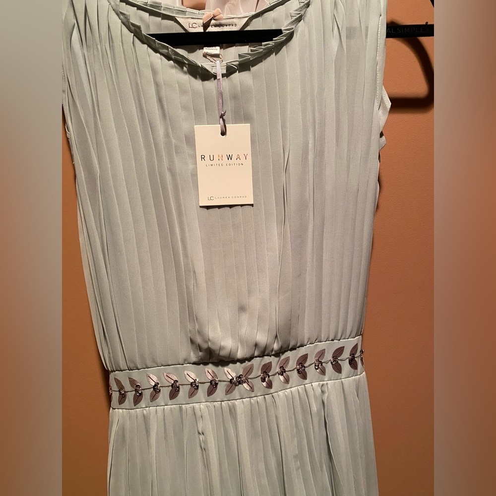 Long classy flowing dress. Brand new. Kept in garment bag.